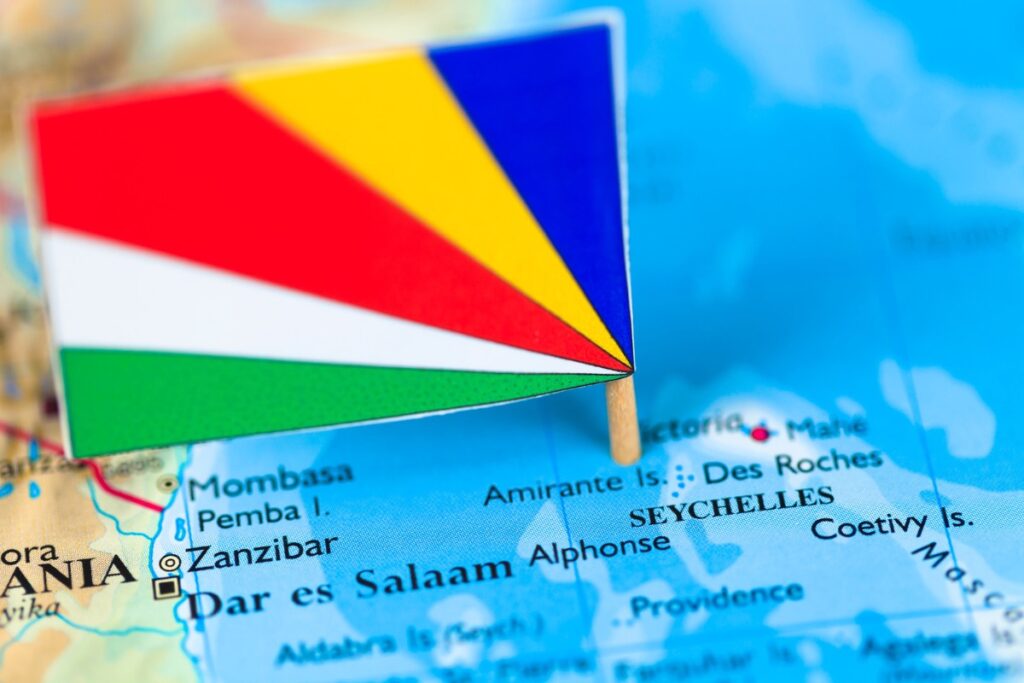 Seychelles flag marking the islands on a map of the Indian Ocean